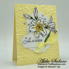 a yellow card with white flowers on it