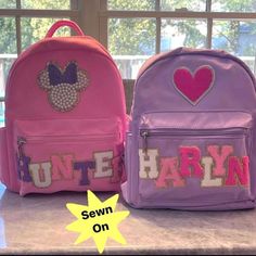 Personalize this high quality nylon mini backpack with the name/word/initials of your choice and make it extra special by adding some fun decorative patches! Please see photos for decorative patch options📸 ⭐️ALL patches are SEWN ON for triple, lasting durability!⭐️ This mini backpack can fit 4-6 letter patches on the top OR 4-5 letter patches on the bottom pocket (depending on the letters in the name/word as some letters are wider than others) 🎨Letter Patch Colors: 2" letters - White, Light Pi Back To School Travel Bags With Logo Patch, School Backpack With Logo Patch, School Backpack With Embroidered Patch, Disney Patch Backpack, Personalized Backpack Kids, 2 Letter, Backpack Patches, Toddler Backpack, Boys Backpacks