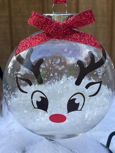 a glass ornament with reindeer's face on it