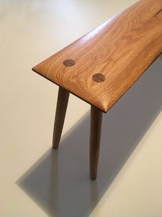 a wooden bench with two holes on it