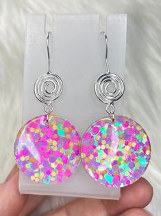 These handmade resin statement earrings add a playful touch to any outfit with their vibrant color pop of pink, yellow, and purple. Each earring features a unique metal swirl, making them one-of-a-kind pieces. Elevate your style with these colorful and chic earrings! Nickle Free - 100% steel Each pair of earrings is unique and handmade. Pink Resin Jewelry For Summer, Trendy Spiral Earrings For Party, Summer Pink Resin Jewelry, Multicolor Resin Jewelry For Party, Rainbow Round Earrings For Party, Pink Resin Earrings For Party, Multicolor Nickel-free Earrings For Party, Nickel-free Multicolor Earrings For Party, Nickel-free Multicolor Resin Jewelry