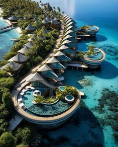 an aerial view of the resort and lagoons in the tropical island, surrounded by blue water