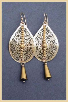 These long swingy earrings add romantic glam to any outfit. Gold tone filigree teardrop dangles and sparkly golden crystals are topped with 14k gold filled ear wires. Perfect to wear with a wedding guest outfit or to sparkle up your favorite party dress. Mix and match with gold tone jewelry to Elegant Gold Long Drop Chandelier Earrings, Handmade Elegant Teardrop Crown Earrings, Elegant Teardrop Earrings With Dangling Beads Gift, Elegant Handmade Teardrop Earrings, Elegant Gift Teardrop Earrings With Dangling Beads, Gold Long Drop Teardrop Earrings For Party, Elegant Festive Teardrop Earrings, Elegant Nickel-free Teardrop Earrings For Party, Gold Teardrop Pendant Earrings For Party