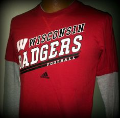 a red wisconsin badgers football shirt hanging on a wall