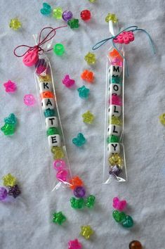 two candy sticks with the words happy written on them and gummy bears around them