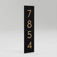 a black and gold sign with the number 7604 on it's front side