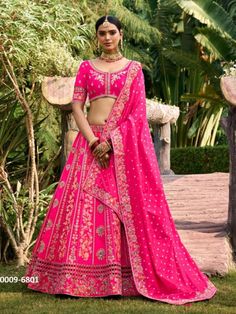 Product Details: Lehenga: Silk  Blouse: Silk  Dupatta: Silk  Color Family: Pink Style: Flared Occasion: Bridal, Wedding Washing Instruction: Dry Wash Blouse Size: M-38 [Margin With 2 Inch Margin Both Side It Can Be Alter Up To 42 Size] The Semi-stitched Lehenga Waist and Hips are customizable Length: 41 Lehenga Waist: Supported Up To 42 Do note: Accessories shown in the image are for presentation purposes only.(Slight variation in actual color vs. image is possible). Raw Silk Choli For Wedding, Dola Silk Lehenga For Wedding, Wedding Dola Silk Lehenga, Raw Silk Meenakari Choli For Receptions, Meenakari Sharara For Wedding, Traditional Drape Lehenga With Meenakari For Reception, Fitted Meenakari Lehenga For Reception, Traditional Drape Meenakari Choli For Reception, Wedding Lehenga In Cutdana Raw Silk