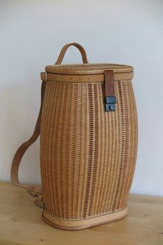 a brown wicker basket sitting on top of a wooden table