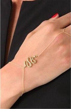 Hip and trendy, and powerful. This body jewelry bracelet features 2 gold chains that wrap around the wrist and finger. Connecting them is an additional chain featuring a snake in strike position. Wear with your jeans and basic tees/tanks, or with your little dresses to add the finishing touch of interest and beauty to your overall look. Size: One size fits most. Wrist chain is adjustable. Material: Gold plated alloy (nickel free) Comes in a gift box. (REGULAR PRICE $19.99) CLEARANCE ITEMS ARE FI Finger Bracelets, Korean Earrings, Sterling Silver Jewelry Rings, Jacquie Aiche, Snake Jewelry, Snake Bracelet, Hand Bracelet, Snake Design, Jewelry Style