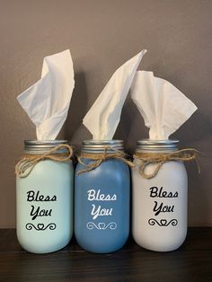 three blue mason jars with white tissue paper in them and the words, please you