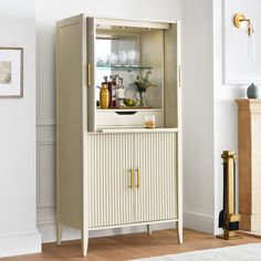 a white cabinet sitting in the middle of a living room