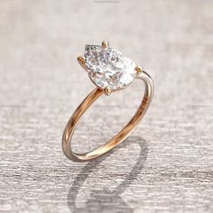 an engagement ring with a pear shaped diamond