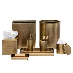 gold bathroom accessories including toiletries, tissue and soap dispenser