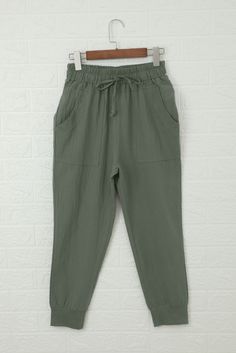 Green Causal Pockets Pants Khaki Lounge Bottoms With Pockets, Khaki Bottoms With Pockets For Loungewear, Khaki Loungewear Bottoms With Pockets, Green Harem Pants With Pockets For Loungewear, Spring Khaki Sweatpants With Pockets, Casual Green Solid Color Bottoms, Casual Solid Green Bottoms, Casual High Waist Capris With Pockets, Casual High-waist Capris With Pockets