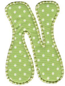 the letter w is made up of green and white polka dot fabric with small white dots on it