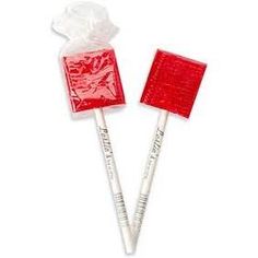 two red lollipops with white wrappers on them