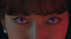 a close up of a person with purple eyes