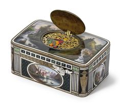 an ornately decorated box with a clock on it's lid is shown in this image