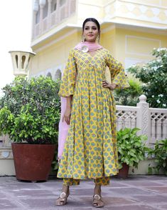 This is a 3-piece set. It comes with soft cotton hand block print anarkali kurta with gota detailing on the neck has 3/4th flared sleeves & ankle length.The set also comes with handblock print pants with semi elasticated waistband and kota doria dupatta with gota patti detailing. Color-Yellow Kurta Fabric-Voil Cotton Bottom Fabric-Voil Cotton Dupatta Fabric-Kota Doria Work-Block Print & Gota Patta Detailing Neck-V Neck Sleeves-3/4th Flared Sleeves Washing Care-Dry Clean Only Ankle-length Block Print Kurta For Navratri, Transitional Yellow Anarkali Set With Long Sleeves, Yellow Long Sleeve Anarkali Set For Transitional Season, Transitional Yellow Long Sleeve Anarkali Set, Bollywood Style Cotton Salwar Kameez Ankle-length, Bollywood Style Cotton Ankle-length Salwar Kameez, Cotton Ankle-length Dupatta For Navratri, Cotton Ankle-length Sets For Navratri, Ankle-length Cotton Dupatta For Navratri