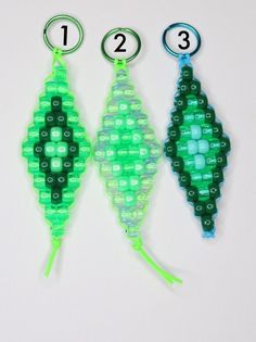 three pieces of green and blue beaded beads with numbers on them, one is shaped like an ornament