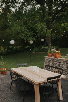 a wooden table sitting in the middle of a yard