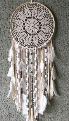 a white dream catcher hanging on the wall