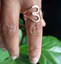 This is a thick gauge slightly adjustable ring designed so that it can be slightly pulled open to get over larger knuckles ,then pressed back closed.  This is a thicker gauge metal and can be requested in a thinner gauge which makes it even easier to open.  Enjoy the subtle caress of warm hand hammered copper gently snuggling your finger.  This is a very well rounded ring which fits the contour of your finger.  Even the edges of the spiral are hand hammered and rounded using an iron ring mandrel Adjustable Spiritual Midi Rings For Promise, Adjustable Open Midi Rings As Promise Rings, Adjustable Open Midi Rings For Promise, Minimalist Adjustable Heart-shaped Midi Rings, Adjustable Hypoallergenic Rose Gold Midi Rings, Adjustable Heart Toe Ring For Promise, Adjustable Rose Gold Metal Ring, Adjustable Minimalist Heart Ring For Promise, Dainty Adjustable Open Heart Rings