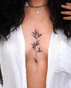 a woman's chest with a flower tattoo on her left side ribcage