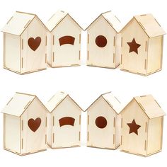 four wooden birdhouses with faces and stars on them, all in different shapes and sizes