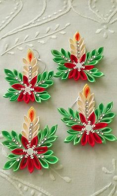 four red, green and white flowers with pearls on them