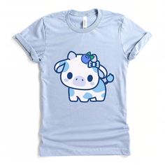 PLEASE NOTE: This is a UNISEX t-shirt. So ladies if you are looking for a tighter fit then consider ordering down a size. If you are looking for a more oversized fit then consider ordering up a size. This cute kawaii blueberry cow tshirt will look great on you! Great gift to give to your friends as well. These t-shirts have-ribbed knit collars to bolster shaping. The shoulders have taping for better fit over time. Dual side seams hold the garment's shape for longer. .: 100% Airlume combed and ri Kawaii Cute Crew Neck Tops, Cute Kawaii Crew Neck Top, Kawaii Crew Neck Top With Cute Design, Blue Harajuku Style Short Sleeve T-shirt, Kawaii Cotton Shirt With Cartoon Print, Cotton Kawaii Shirt With Cartoon Print, Cute Blue Cotton T-shirt, Cute Blue Tops With Graphic Print, Light Blue Graphic Tee With Cartoon Print