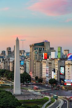 the washington monument is in the center of this cityscape with tall buildings on both sides