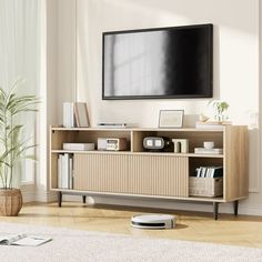 a living room with a television on the wall and a rug in front of it