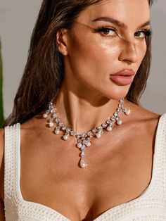 Indulge in the perfect blend of elegance and glamour with the Zala Crystal Pearl Fringe Necklace. Hand-crafted with intricate crystal and pearl detail, this necklace is a stunning addition to any outfit. Elevate your style and turn heads with its eye-catching fringe design.    M  aterial:   Crystal Pearl Fringe, Fringe Necklace, Swimwear Sale, Crystal Pearls, Elevate Your Style, Your Style, Hand Crafted, Crystals, Design