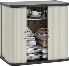 an open storage cabinet with towels and other items in the cupboards on top of it