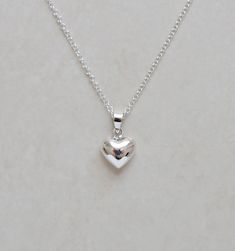 "A super shiny sterling silver puffed heart is suspended from a shimmery sterling silver chain....simple and delicate - great for everyday! ✩ Sterling silver heart pendant is 0.5\". ✩ 1.5mm rolo chain is finished with a high-quality spring ring clasp to form the closure. All chain components are 925 sterling silver. Total length is end-to-end including all clasps. If you would like a length other than what is listed, simply choose the closest and leave us a note at checkout. ✩ Personalize it here: http://etsy.me/2zhF3rc ✩ Comes beautifully packaged as shown in a branded box with care instructions. If this is intended as a gift, please let us know when you check out...that way we can include a blank gifting card for you! ~ More heart jewelry: http://etsy.me/1ttcC4g ~ Please be sure to read Luxury Sterling Silver Charm Necklace With Heart Pendant, Heart Jewelry Silver, Silver Dainty Heart Necklace, Simple Silver Heart Charm Necklaces, Simple Silver Heart Charm Necklace, Simple Sterling Silver Heart Charm Necklace, Simple Silver Heart Pendant Necklace, Dainty Silver Heart Necklace, Simple Sterling Silver Heart Pendant Necklace