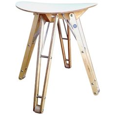 a small wooden table with two legs and a white top on a white background in the shape of an airplane