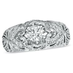 an antique style diamond ring with filigrees