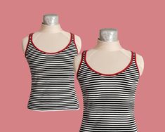 This tank is a classic staple for your wardrobe! It has slim black and white stripes and the neckline/straps are lined with red fabric. It is super stretchy so it can fit a variety of sizes! Wear with a pair of red sunglasses and enjoy the summer sun!  Sizing: Bust- unstretched (15") stretched (21.5") Waist: unstretched (14") stretched (24") As always, it's important to mention that all my vintage items are sold 'as-is,' and I cannot accept returns. I encourage you to thoroughly inspect the pict Striped Fitted Tank Top With Tank Straps, Sleeveless Cotton Tank Top With Contrast Stripes, Cotton Sleeveless Tank Top With Contrast Stripes, Fitted Tank Top With Contrast Stripes For Spring, Fitted Striped Tank Top, Fitted Striped Sleeveless Tank Top, Fitted Sleeveless Top With Vertical Stripes, Striped Stretch Tank Top, Striped Fitted Tops With Tank Straps