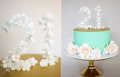 two cakes decorated with white flowers on top of each other and the letter d is made out of frosting