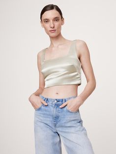 We cut this elegantly understated top from a high-shine satin, keeping the silhouette free from ornament so it’s the perfect blank canvas.  Fitted: Slim.  Sits close to the body.  Square neck.  Invisible zip at back.  Hidden elastic panels at back for a custom fit.  Fully lined.  Fitted: Slim.  Sits close to the body.  Sleeveless.  Cropped length.  Model: Size S, 5'10" (178cm). Satin Cropped Top For Evening, Evening Satin Cropped Top, Cropped Satin Top For Evening, Sleek Party Tops With Sheen Detail, Sleek Party Tops With Sheen, Sleek Party Top With Sheen, Sleek Sheen Party Top, Fitted Top With Satin Finish For Night Out, Elegant Silk Crop Top