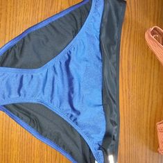 Blue And Black Bikini Bottom With Zipper Compartment On Back Waist Band. 80 Percent Nylon, 20 Spandex Lining 100 Percent Poly Panty Liner In Place Blue Stretch Swimwear With Go-dry, Blue Stretch Swimwear For Training, White Swim Trunks, High Neck Tankini, 80 Percent, Panty Liner, Swim Pants, Womens Tankini, Printed Tankini