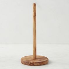 a wooden pen holder on a white surface