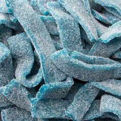 closeup of blue and white candy canes with frosting on them, as if they were frozen