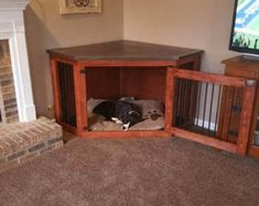 a dog is laying in his bed under the entertainment center next to the fire place