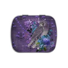 an owl sitting on top of purple flowers