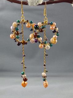 Multicoloured Cascading Pearl Hoop Dangle Earrings Gold Filled, Boho Bridal Earrings, Long Colored Pearl Earrings, June Birthstone Gift______________________________A gorgeous and unique pair of earrings handcrafted with high quality natural multi coloured cultured Pearls. The perfect finishing touch to your outfit whatever the occasion.The earrings are approximately 4 inches in length which can be altered to your preference and the hoops are 1 inch in size.Made from gold filled plated copper an Cascading Pearl Earrings, Boho Bridal Earrings, Framed Jewelry, Hoop Dangle Earrings, Dangle Earrings Gold, Earrings Diy, Gold Pearl Earrings, Pearl Hoop Earrings, Boho Bridal