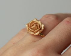 Gold rose made of polymer clay. Material of band- gold plated sterling silver Floral ring with sculpted flower EACH PETAL MADE BY HAND Dia rose about 15 mm/ 0,59 inch THE BASE IS ADJUSTABLE: gold plated sterling silver 925 base 5.5-8 or 7-9 size The ring is adjustable and can fit any size by gently pushing together the ends, overlapping them or gently pulling them apart. Before sending I will place this ring in small box ♥All my rings come in boxes.. If you are purchasing a gift I will wrap the Elegant Handmade Rose Gold Flower Ring, Gold 3d Flower Jewelry For Gift, Gold 3d Flower Jewelry Gift, Adjustable Gold Ring With Rose Design, Yellow Gold Rings With Rose Design For Gift, Gold Jewelry With 3d Flowers For Jewelry Making, Rose Jewelry With 3d Flowers For Gift, Rose Gold Jewelry With 3d Flowers For Gift, Formal Rose Colored Ring Jewelry