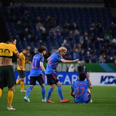 the soccer players are celebrating on the field