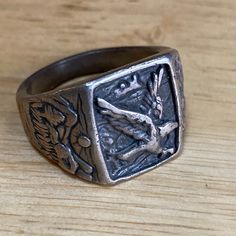 Up for sale is this vintage majestic eagle signet ring sterling silver in size 9.5.  The face of the ring measures 7/8" wide by 5/8" high and the piece weighs 11.9 grams.  The inside of the ring is stamped copyright symbol "S" and .925.  Note that some photos are enlarged to show details. Condition:  This piece is pre-owned and vintage and as-such, expect wear... surface scratches or surface wear, and it may need to be cleaned.  This item is sold in as-is condition. Please make sure to examine a